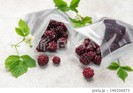 Frozen blackberries in vacuum bags for food preservation Frozen blackberries in vacuum bags for food preservation 140108873