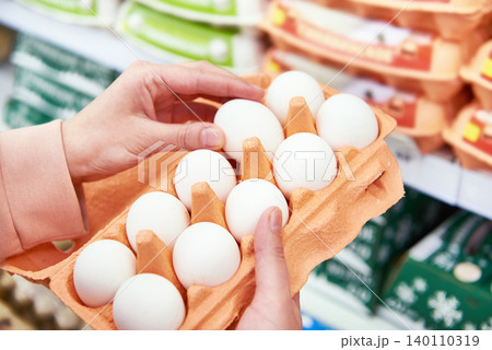 Woman with packing eggs in shop 140110319