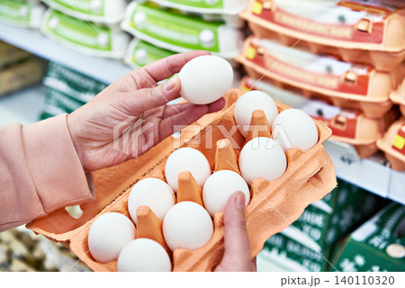Woman with packing eggs in shop Woman with packing eggs in shop 140110320