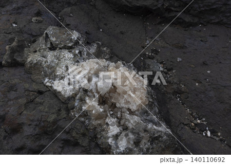 Close-up of natural calcite crystals embedded in a dark rock matrix Close-up of natural calcite crystals embedded in a dark rock matrix 140110692