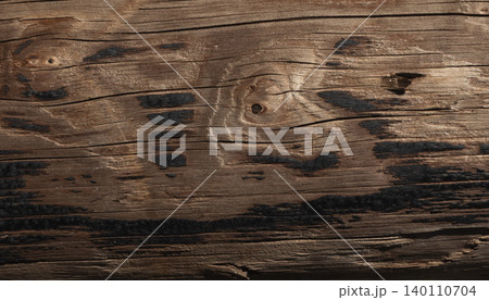Weathered wooden surface with dark burnt marks and natural grain texture Weathered wooden surface with dark burnt marks and natural grain texture 140110704