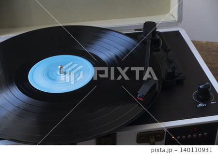 Vinyl record spinning on turntable side view 140110931