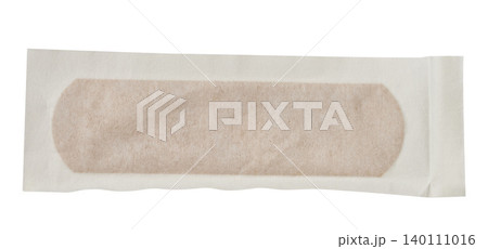 Brown medical plaster in a sealed paper protective package on an isolated background 140111016