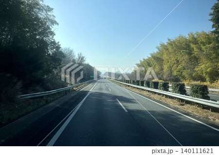 青空の下をまっすぐ伸びる郊外道路 青空の下をまっすぐ伸びる郊外道路 140111621