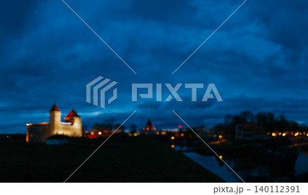 Blurred bokeh view of illuminated Kuressaare Castle at winter night Blurred panoramic night view of Kuressaare Castle and town park 140112391