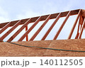 Assemble wood frames for new building using wooden beams at construction site while they work. 140112505
