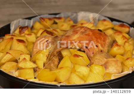 Roasted Chicken Drumsticks with Potatoes on Tray 140112659