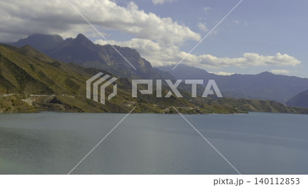 Quiet Water Reflection Scene, Peaceful Landscape Featuring Mountains And Calm Water Under Sunny Sky. Creative 140112853