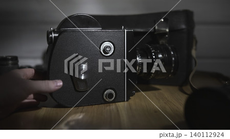 Vintage Camera With Mechanical Focusing Rings. Classic Film Camera On Wood With Lens And Shadows . Media 140112924