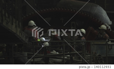 Workers Fix Machinery. Team Members Focus On Repairing Complex Industrial Machinery Carefully . Stock clip Workers Fix Machinery. Team Members Focus On Repairing Complex Industrial Machinery Carefully . Stock clip 140112931