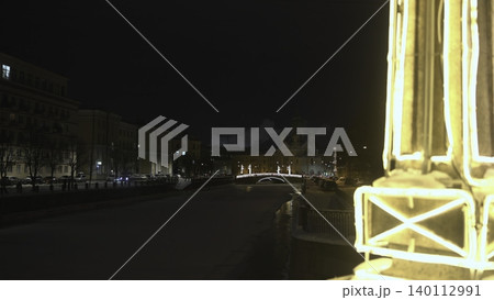 Nighttime Scene With Glowing Lamp. Softly Glowing Lamp Highlights Distant Cityscape And Winter Street. Media Nighttime Scene With Glowing Lamp. Softly Glowing Lamp Highlights Distant Cityscape And Winter Street. Media 140112991