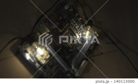 Electronics Testing Scene. Inspection Of Circuit Board With Diagnostic Equipment In Dim Workspace. Media Electronics Testing Scene. Inspection Of Circuit Board With Diagnostic Equipment In Dim Workspace. Media 140113000