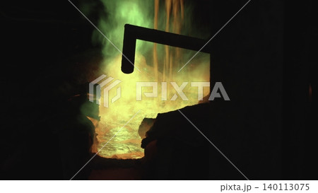 Bright Flames Illuminate Dark Interior. Vivid Scenes Of Molten Metal Flowing Under Green Flames And Smoke . Stock clip 140113075