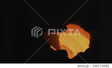 Inspection Of Fiery Core Within Furnace. Bright Orange Glow Emanates From Heated Industrial Chamber . Stock clip Inspection Of Fiery Core Within Furnace. Bright Orange Glow Emanates From Heated Industrial Chamber . Stock clip 140113092