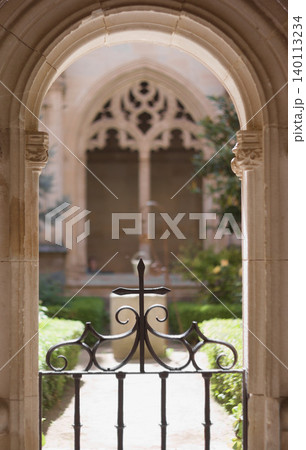 Arch and iron fence with a cross in a monastery Arch and iron fence with a cross in a monastery 140113234