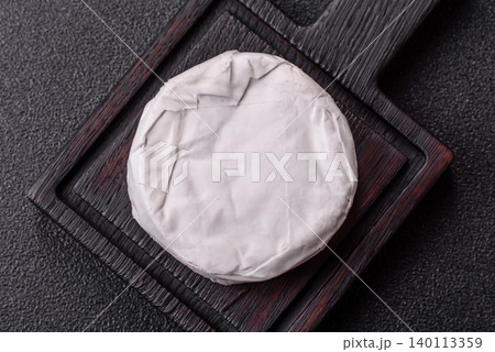 Pink Brie or Camembert cheese with honey, jam, figs, and crackers. Brie cheese Pink Brie or Camembert cheese with honey, jam, figs, and crackers. Brie cheese 140113359