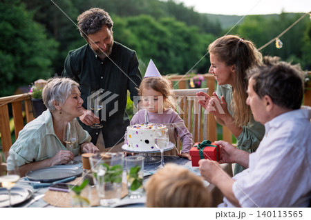 Little girl blowing candle from birthday cake. Little girl blowing candle from birthday cake. 140113565