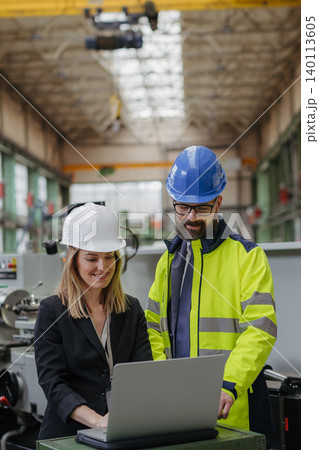 Engineering manager and mechanic worker doing routine check up in industrial factory Engineering manager and mechanic worker doing routine check up in industrial factory 140113605
