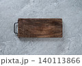 Rustic wooden serving board on gray stone background 140113866