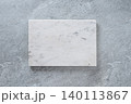 White marble board on gray stone background 140113867