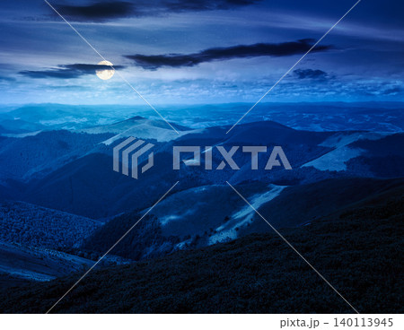 mysterious mountain landscape in summer at night. travel ukraine background. full moon over rolling hill in dappled light. scenic view of borzhava ridge. carpathian mountain scenery mysterious mountain landscape in summer at night. travel ukraine background. full moon over rolling hill in dappled light. scenic view of borzhava ridge. carpathian mountain scenery 140113945