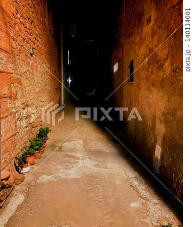 Dark narrow alley at night with terracotta flower pots in Barcones village, Soria, Spain Dark narrow alley at night with terracotta flower pots in Barcones village, Soria, Spain 140114001