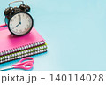 Pink girlish school supplies, notebooks and pens on punchy blue. 140114028