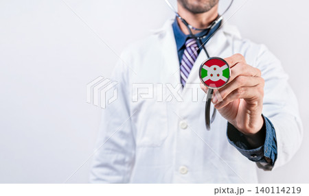 Burundi healthcare system, doctor holding stethoscope. Burundi health and medical insurance concept Burundi healthcare system, doctor holding stethoscope. Burundi health and medical insurance concept 140114219