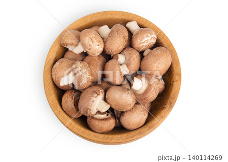 Brown champignon mushroom a wooden bowl isolated on white background. Top view. Flat lay Brown champignon mushroom a wooden bowl isolated on white background. Top view. Flat lay 140114269