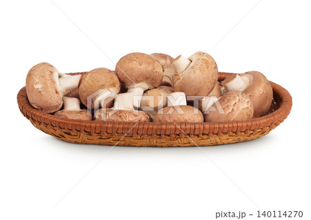 Brown champignon mushroom in a wicker basket isolated on white background Brown champignon mushroom in a wicker basket isolated on white background 140114270