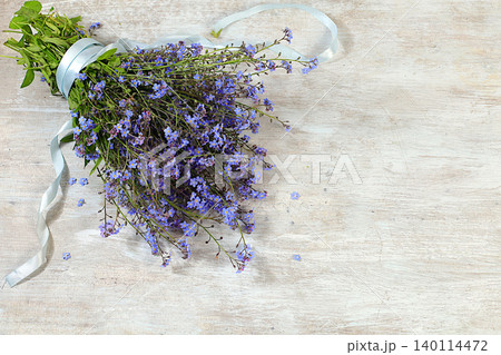 Beautiful spring forget-me-nots on a sunny background, abstract floral arrangement, still life with spring flowers of different varieties, floral greeting card, screen banner, design template 140114472