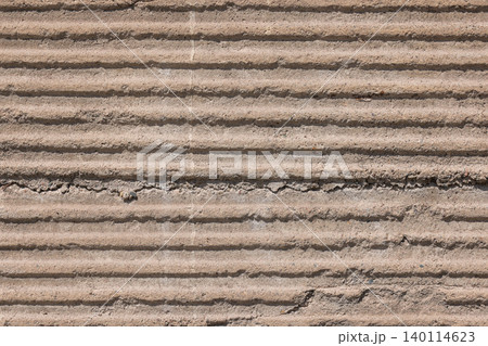 Textured Concrete Wall with Horizontal Ridges and Grooves 140114623