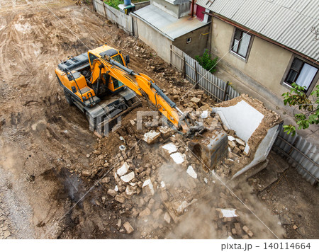 Excavator Demolishing Building at Urban Construction Site Excavator Demolishing Building at Urban Construction Site 140114664