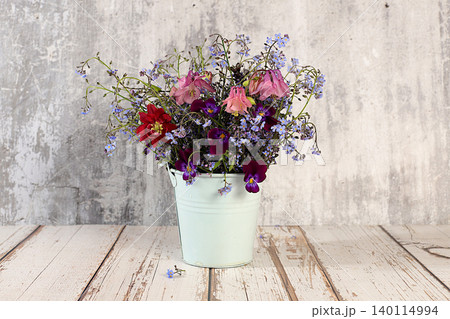 Beautiful spring forget-me-nots, violets, columbine on a sunny background, abstract floral arrangement, still life with spring flowers of different varieties, floral greeting card, screen banner, 140114994