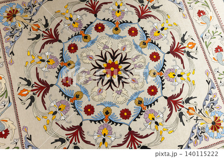 Intricate hand-embroidered suzani textile featuring a circular floral medallion, Intricate hand-embroidered suzani textile featuring a circular floral medallion, 140115222