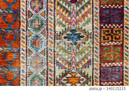 Close-up of a colorful handmade Persian rug, background photo Close-up of a colorful handmade Persian rug, background photo 140115225