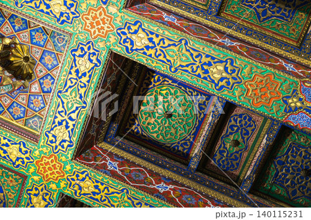 Ornate Islamic ceiling with vibrant geometric patterns and arabesque motifs Ornate Islamic ceiling with vibrant geometric patterns and arabesque motifs 140115231