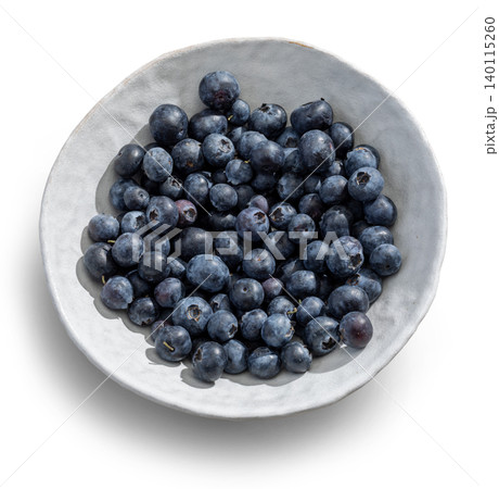 Fresh Blueberries in a Rustic Ceramic Bowl Isolated on White. Top View Fresh Blueberries in a Rustic Ceramic Bowl Isolated on White. Top View 140115260