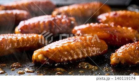 barbecuing tasty chicken wings on a grill . roasted chicken wings. barbecuing tasty chicken wings on a grill . roasted chicken wings. 140119174