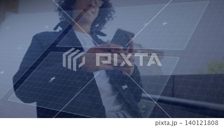 Holding smartphone, man tapping screen in office wearing dark blazer and glasses with HUD overlay Holding smartphone, man tapping screen in office wearing dark blazer and glasses with HUD overlay 140121808