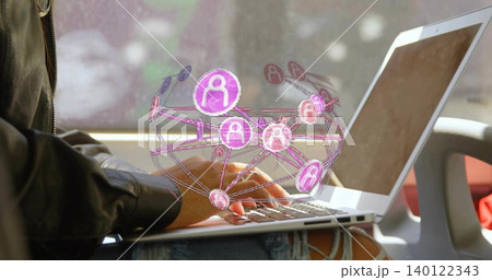 Typing woman wearing black leather jacket ripped jeans using laptop in train seat with pink network Typing woman wearing black leather jacket ripped jeans using laptop in train seat with pink network 140122343