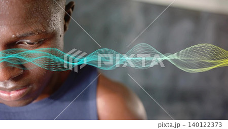 Gazing male athlete wearing navy sleeveless top at studio, with waveform graphic, copy space Gazing male athlete wearing navy sleeveless top at studio, with waveform graphic, copy space 140122373