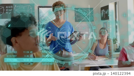 Presenting teacher in blue top holding tablet at classroom front, showing holographic HUD Presenting teacher in blue top holding tablet at classroom front, showing holographic HUD 140122394