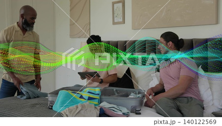 Packing three men arranging casual clothes on bed at home, with open suitcase, tablet, digital wave Packing three men arranging casual clothes on bed at home, with open suitcase, tablet, digital wave 140122569