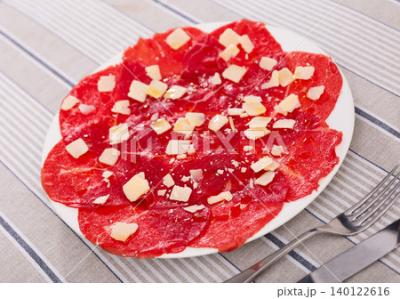 Carpaccio - appetizer made with thin slices of raw meat and parmesan cheese 140122616