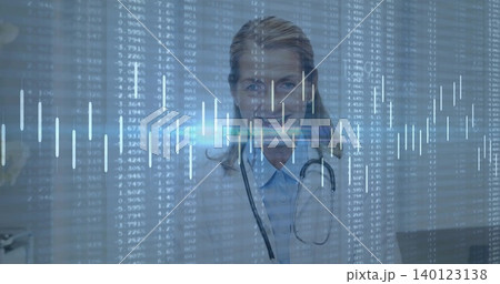 Standing doctor facing in clinic wearing lab coat, collared shirt and stethoscope with data overlay Standing doctor facing in clinic wearing lab coat, collared shirt and stethoscope with data overlay 140123138