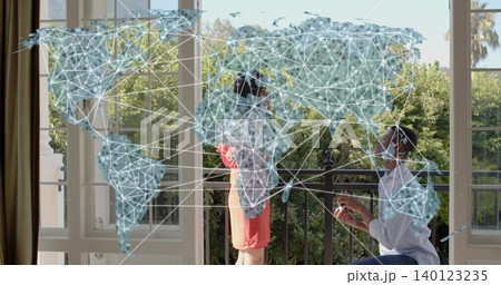 Kneeling man offering ring box to woman in coral short dress on balcony with map overlay Kneeling man offering ring box to woman in coral short dress on balcony with map overlay 140123235