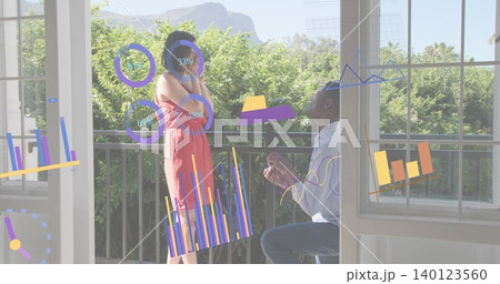 Kneeling man holding ring box proposing to woman in coral dress on balcony, AR charts Kneeling man holding ring box proposing to woman in coral dress on balcony, AR charts 140123560