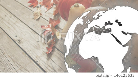 Overlaying globe graphic halftoning Europe Africa over wooden tabletop with pumpkins squash leaves Overlaying globe graphic halftoning Europe Africa over wooden tabletop with pumpkins squash leaves 140123633