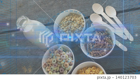 Displaying five white bowls holding cereals on gray woodgrain table, with milk bottle and spoons Displaying five white bowls holding cereals on gray woodgrain table, with milk bottle and spoons 140123703